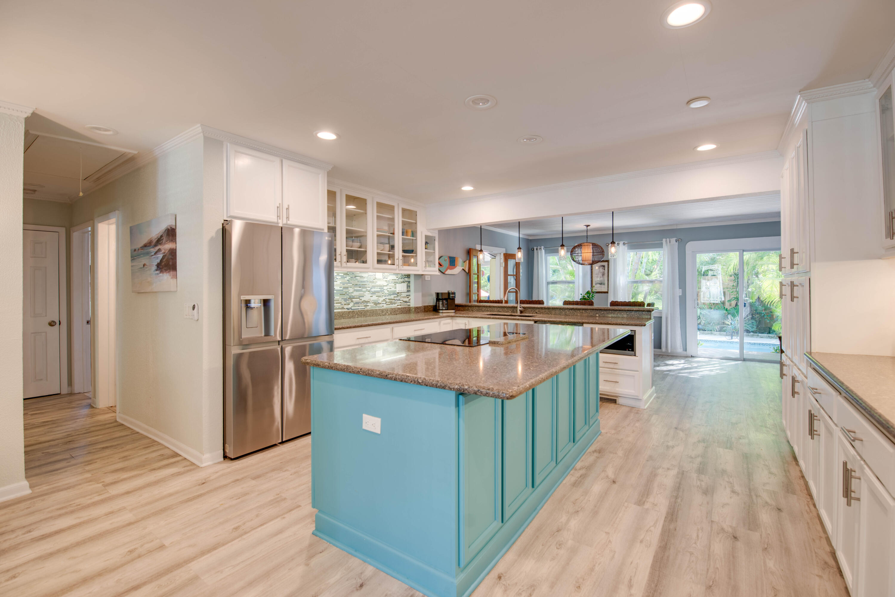 2828 Harris Avenue Key West, FL 33040 - Photo 36 of 45 a kitchen with stainless steel appliances granite countertop a refrigerator a sink dishwasher a stove and a dining table with wooden floor
