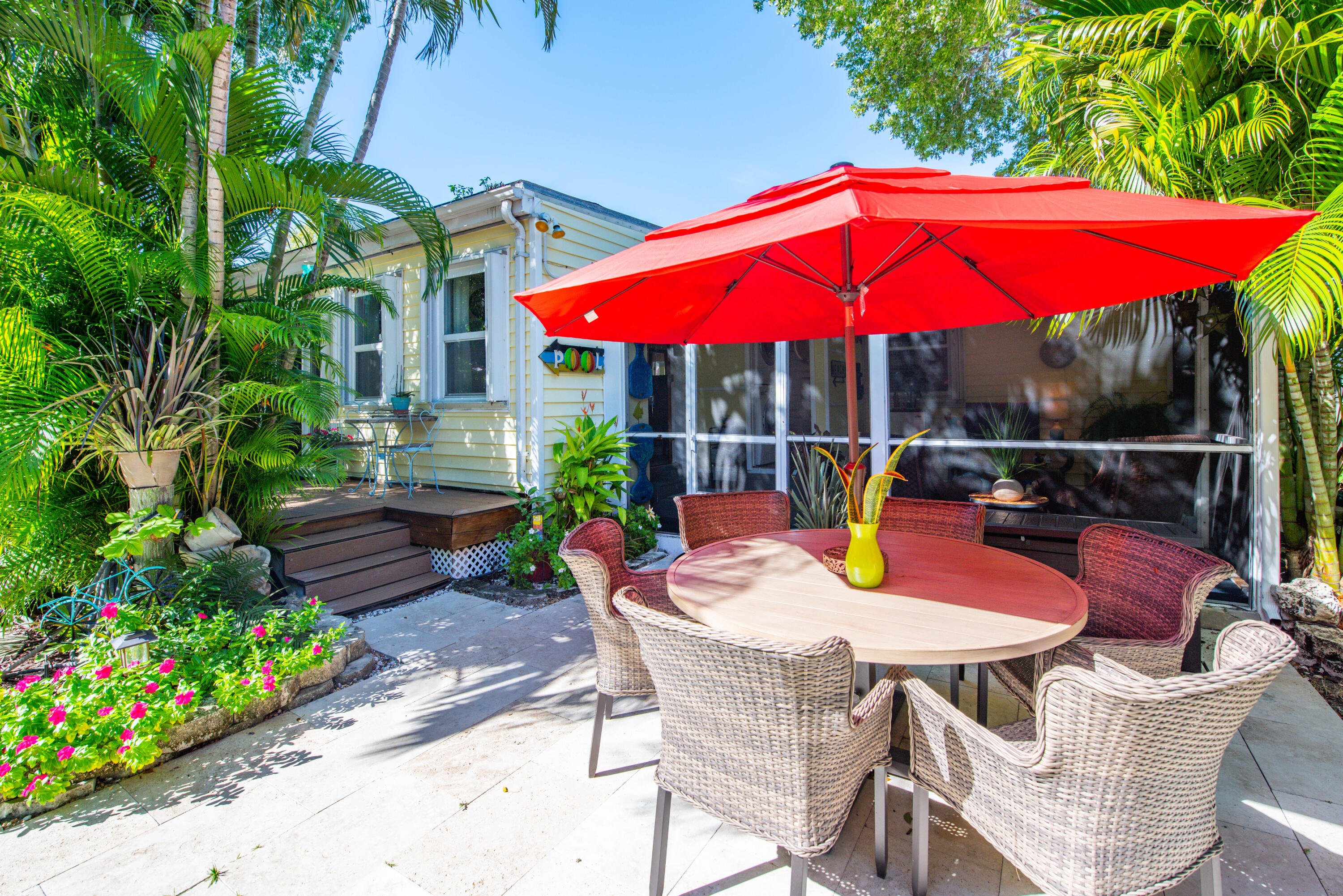 2828 Harris Avenue Key West, FL 33040 - Photo 40 of 45 a view of a patio with a table and chairs under an umbrella