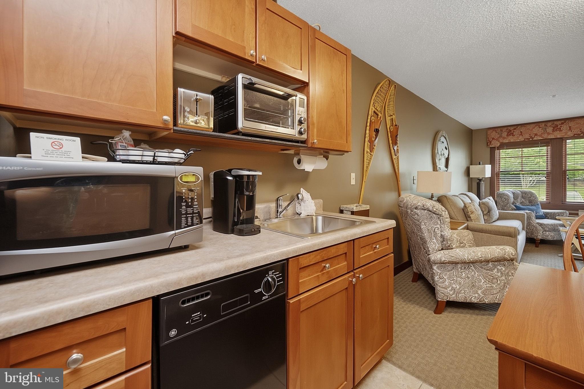 565 Glendale Road, Unit 208A Oakland, MD 21550 - Photo 6 of 51 a kitchen with stainless steel appliances a stove a sink and a microwave
