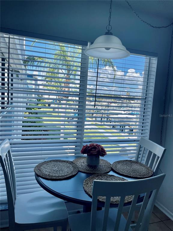 165 Medallion Boulevard, Unit H Madeira Beach, FL 33708 - Photo 12 of 20 a table and chairs in a balcony