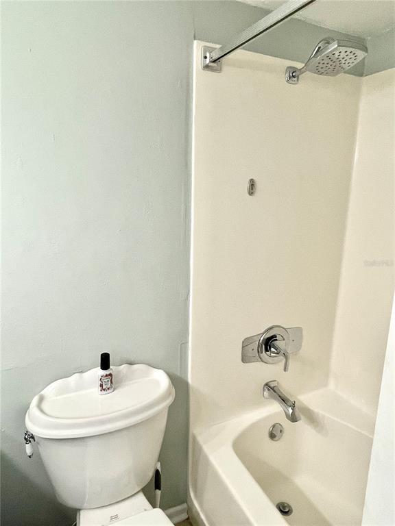 165 Medallion Boulevard, Unit H Madeira Beach, FL 33708 - Photo 18 of 20 a white toilet sitting next to a bathroom sink