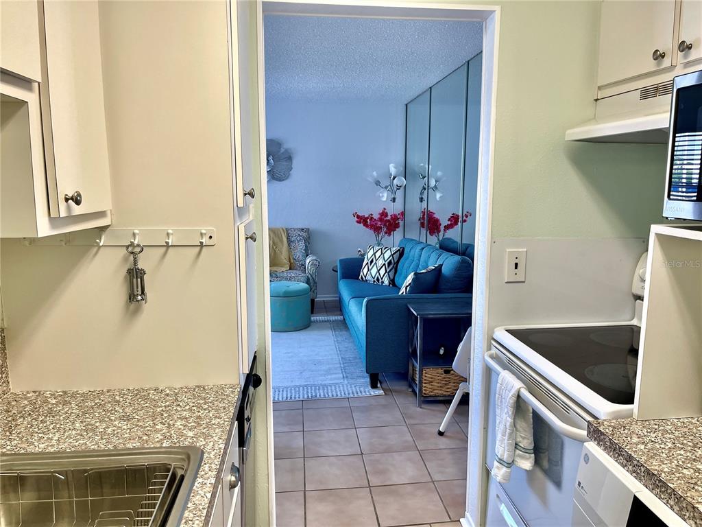 165 Medallion Boulevard, Unit H Madeira Beach, FL 33708 - Photo 7 of 20 view of a living room with a sink and a stove top oven