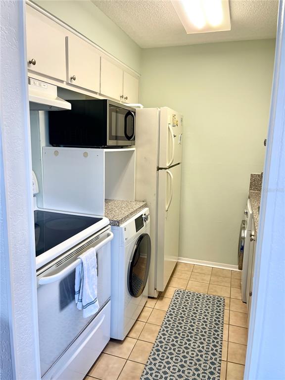165 Medallion Boulevard, Unit H Madeira Beach, FL 33708 - Photo 8 of 20 a utility room with dryer and washer