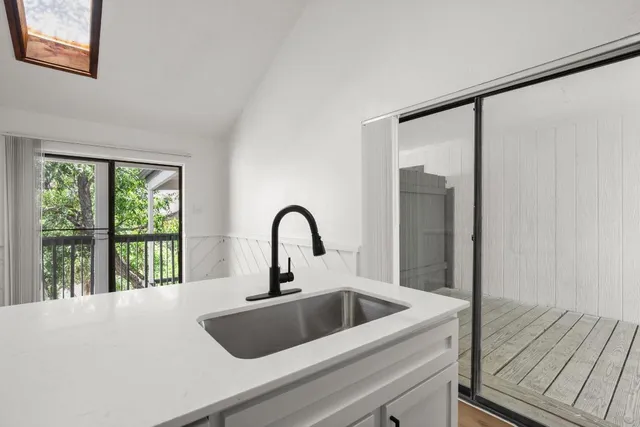 a kitchen with a sink and large window