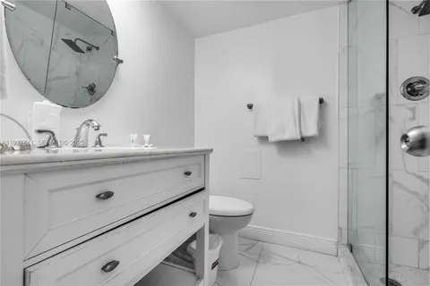 a bathroom with a sink mirror vanity and toilet