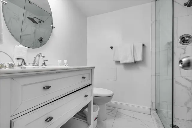 a bathroom with a sink mirror vanity and toilet