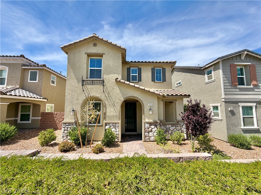 This charming residence features architectural stone accents and lush, easy-care landscaping.