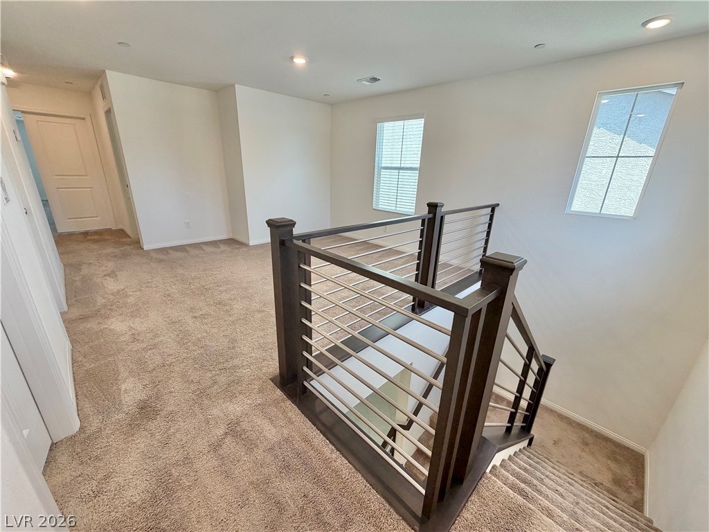 3624 Bitonto Lane Henderson, NV 89044 - Photo 10 of 28 This carpeted loft features modern railings and abundant natural light.