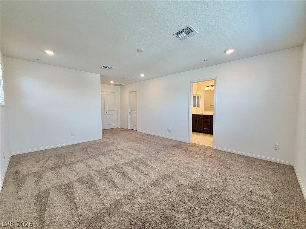 3624 Bitonto Lane Henderson, NV 89044 - Photo 14 of 28 This spacious living area offers plush carpeting and leads to a well-appointed bathroom.