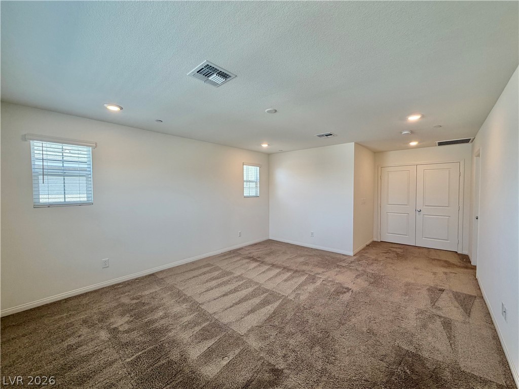 3624 Bitonto Lane Henderson, NV 89044 - Photo 15 of 28 This spacious room features ample natural light, soft carpet, and functional recessed lighting.