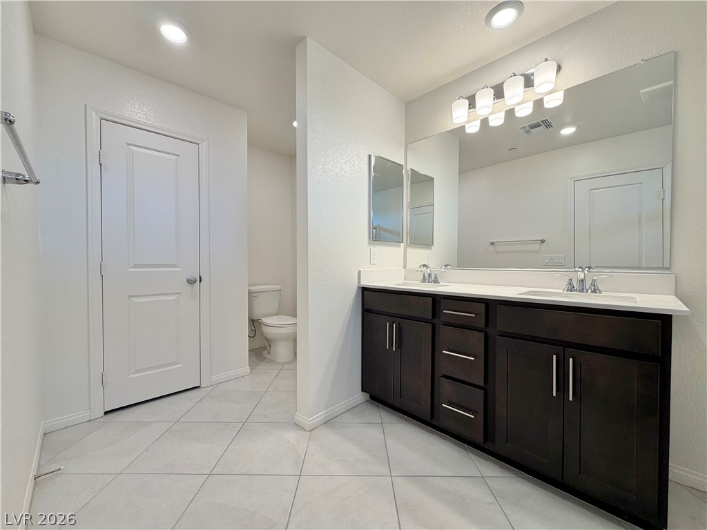 3624 Bitonto Lane Henderson, NV 89044 - Photo 16 of 28 This primary bathroom boasts a double vanity with ample storage and a private water closet.