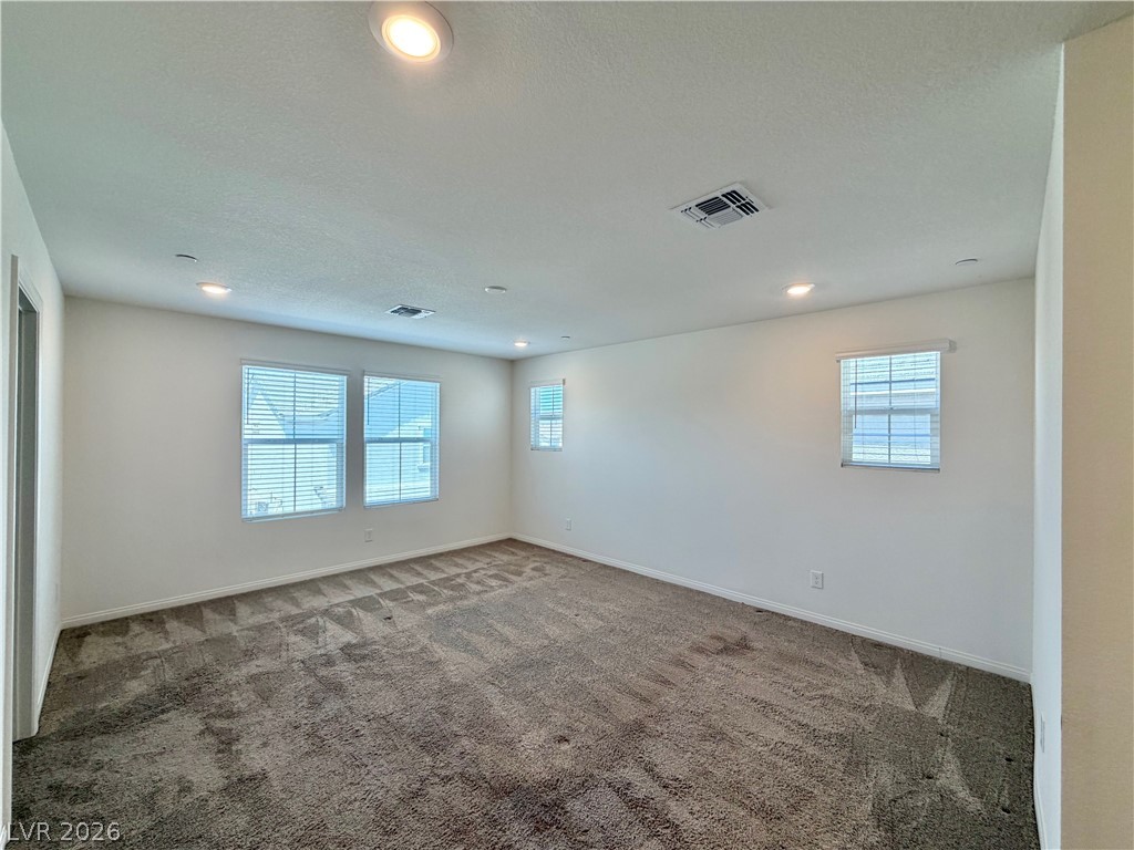 3624 Bitonto Lane Henderson, NV 89044 - Photo 20 of 28 This spacious area features multiple windows and soft carpeting, creating a comfortable and inviting atmosphere.