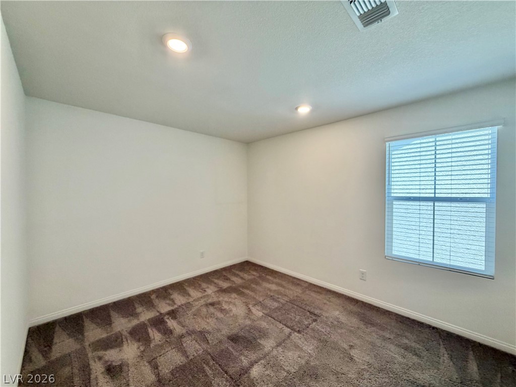 3624 Bitonto Lane Henderson, NV 89044 - Photo 23 of 28 This bright bedroom features recessed lighting and plush carpet, creating a comfortable living space.