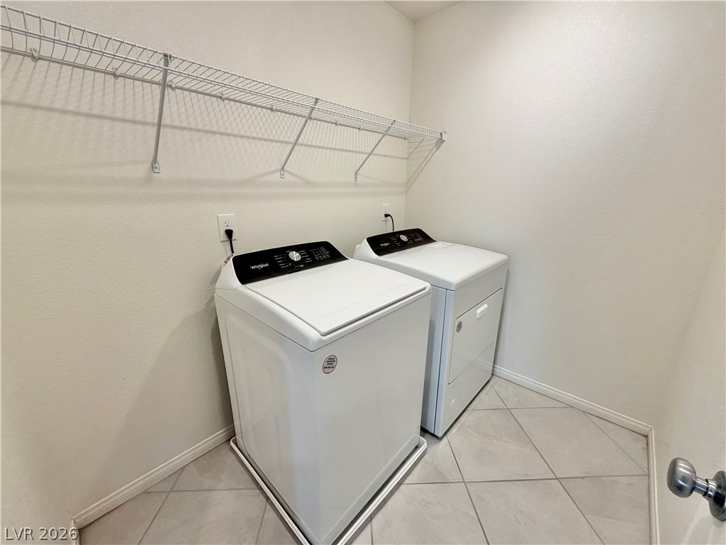 3624 Bitonto Lane Henderson, NV 89044 - Photo 26 of 28 This dedicated laundry room features functional shelving and a tiled floor for practical living.