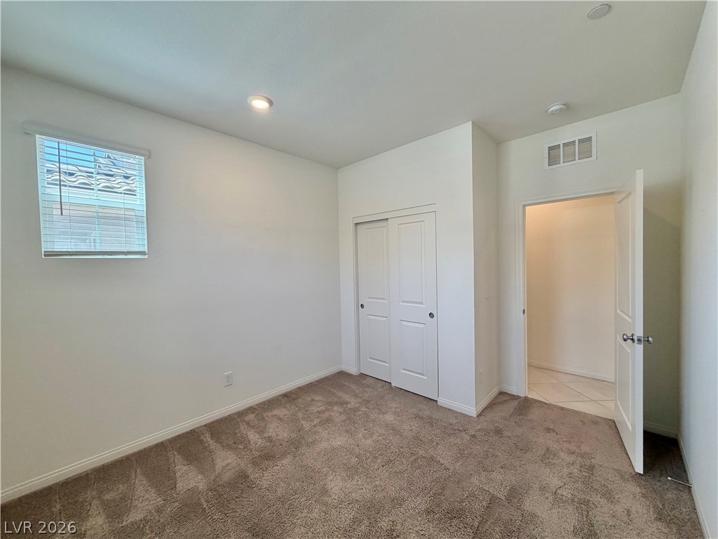 3624 Bitonto Lane Henderson, NV 89044 - Photo 7 of 28 This cozy bedroom provides a comfortable retreat with soft carpet flooring and natural light.