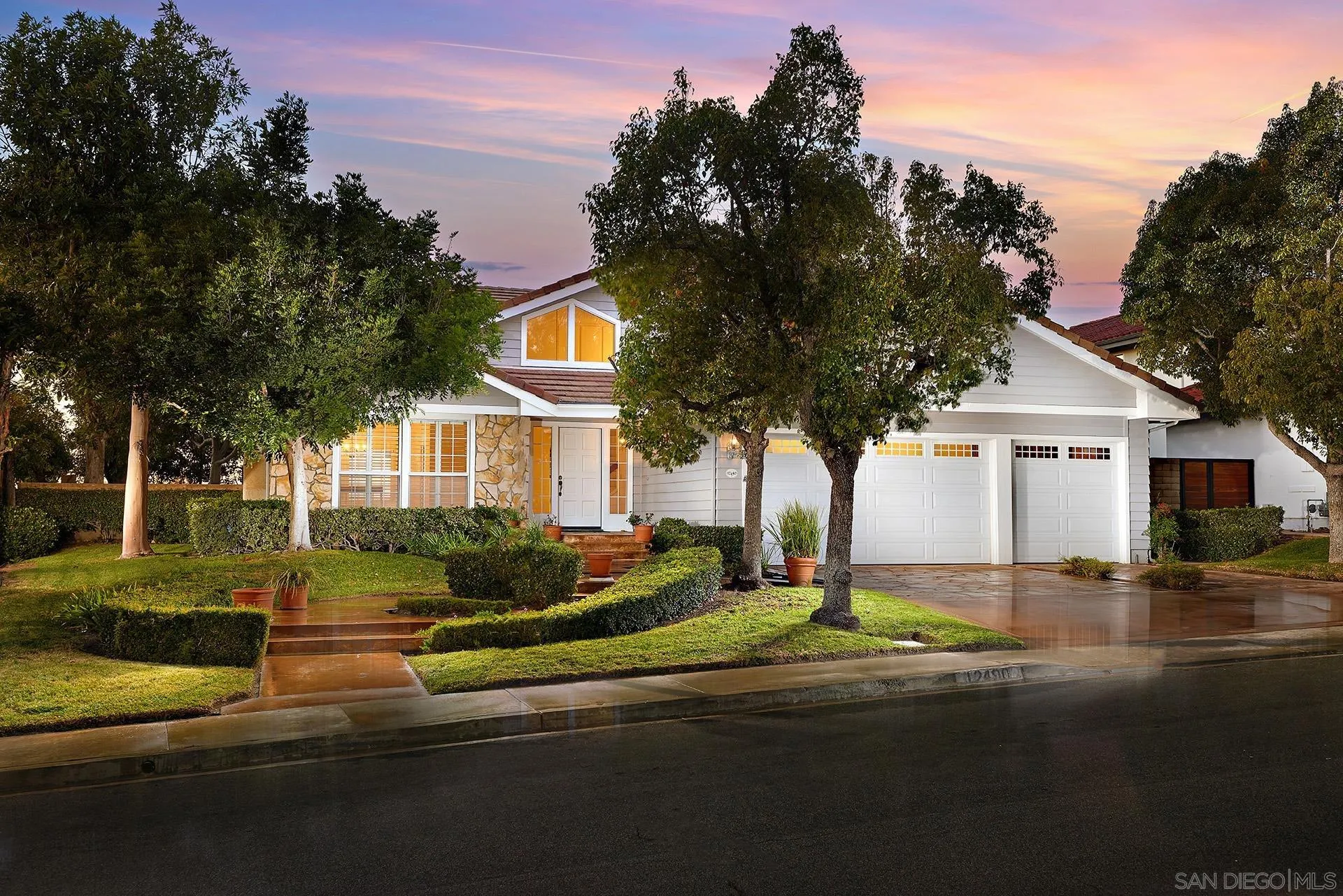 12490 Rue Cheaumont San Diego, CA 92131 - Photo 1 of 58 a front view of a house with a yard and garage