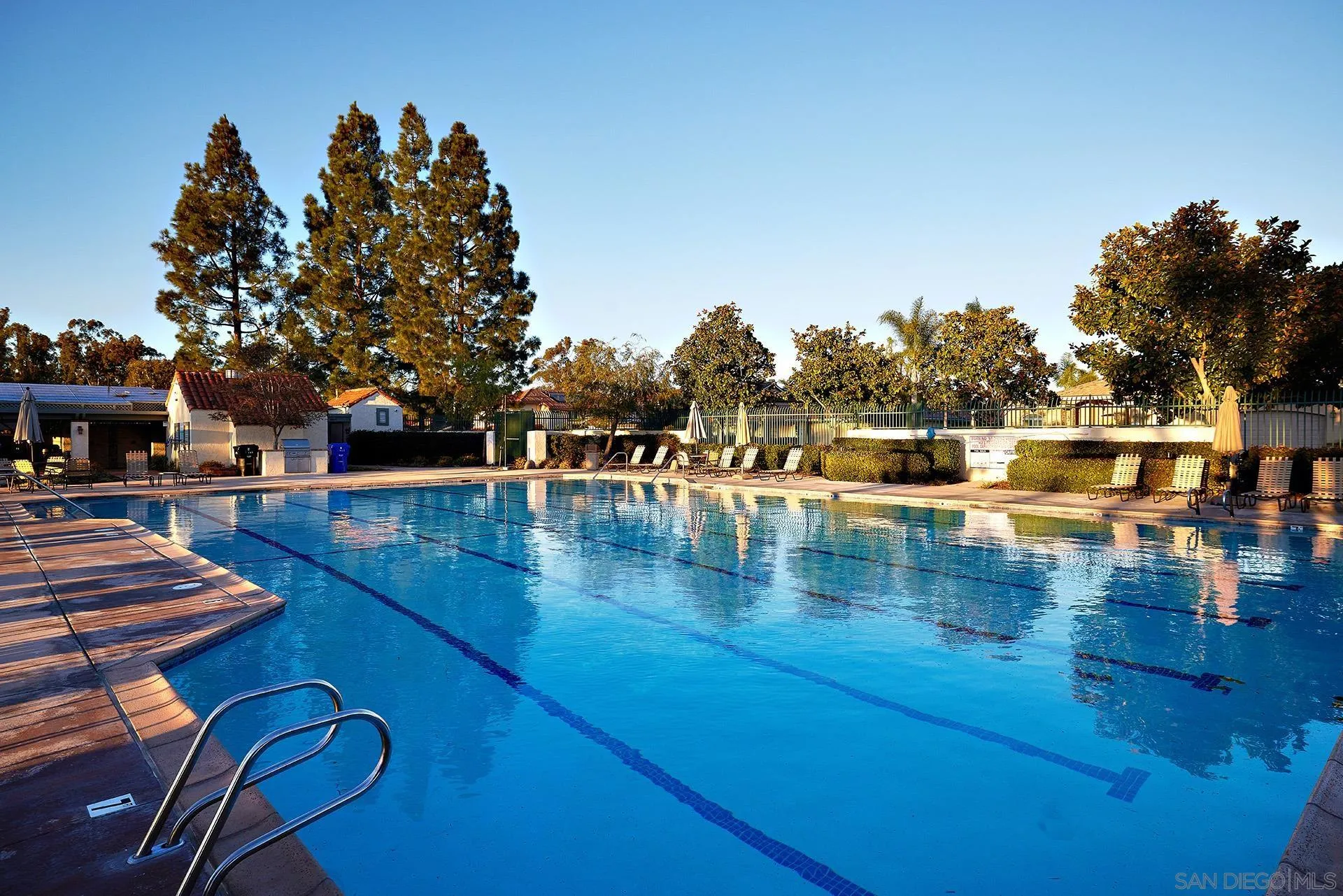 12490 Rue Cheaumont San Diego, CA 92131 - Photo 13 of 58 a view of swimming pool with seating space and trees in the background