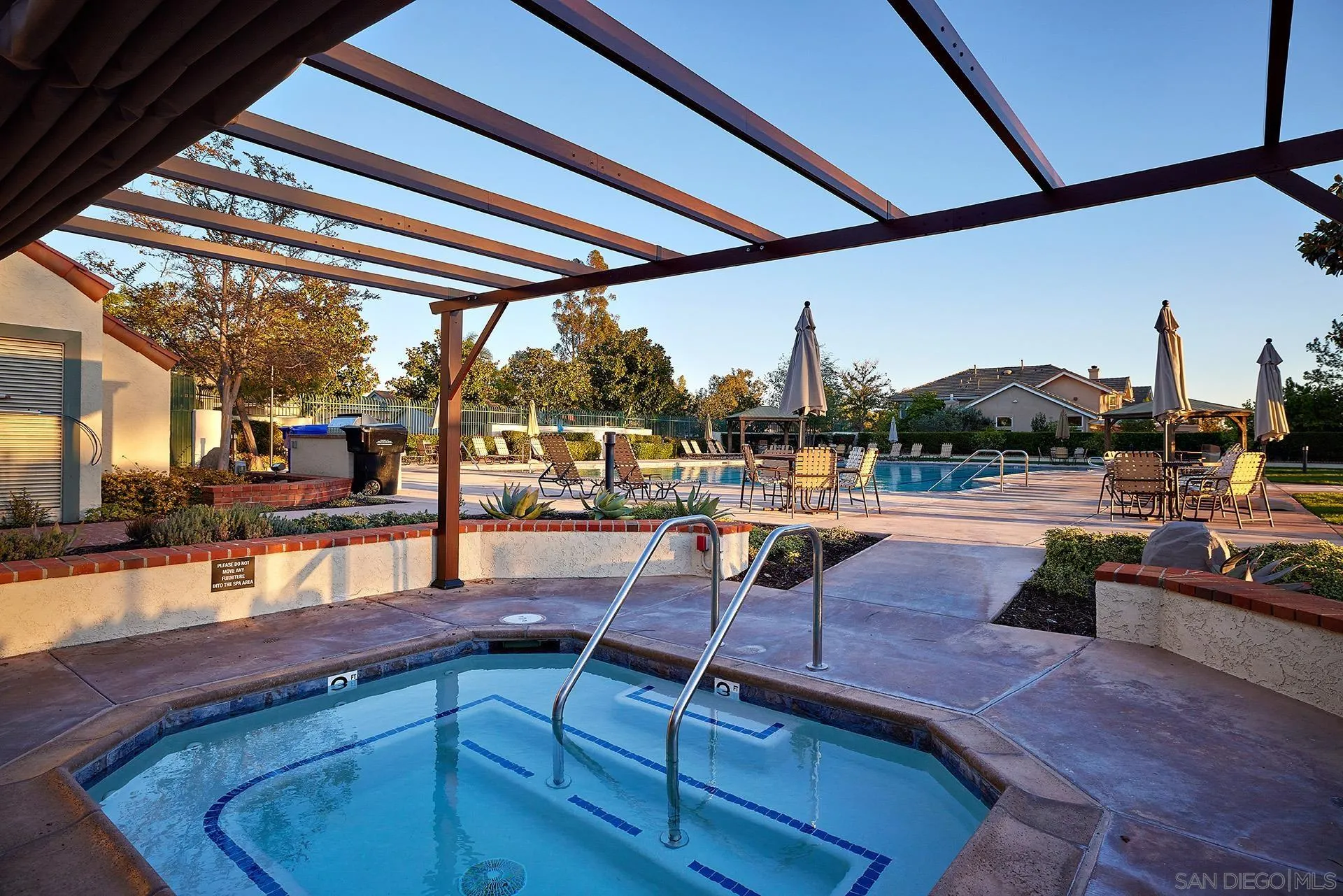 12490 Rue Cheaumont San Diego, CA 92131 - Photo 16 of 58 a swimming pool with outdoor seating