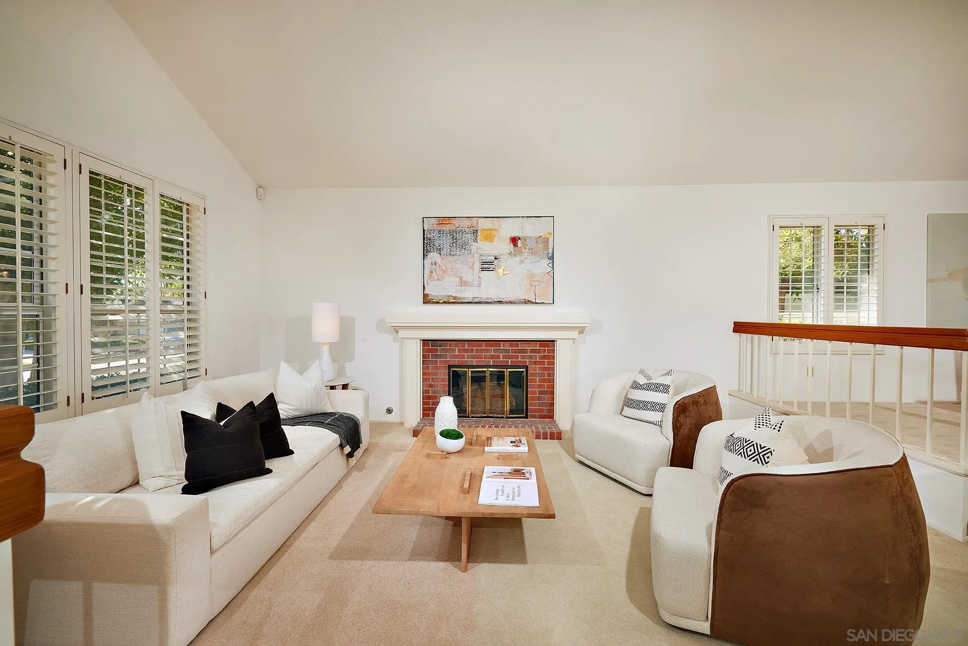 12490 Rue Cheaumont San Diego, CA 92131 - Photo 20 of 58 a living room with furniture two windows and a fireplace