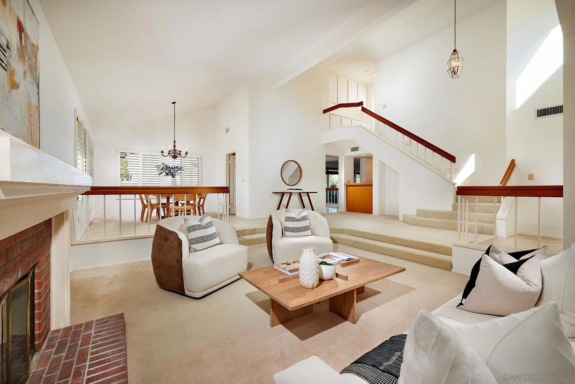 12490 Rue Cheaumont San Diego, CA 92131 - Photo 21 of 58 a living room with furniture a rug and a fireplace