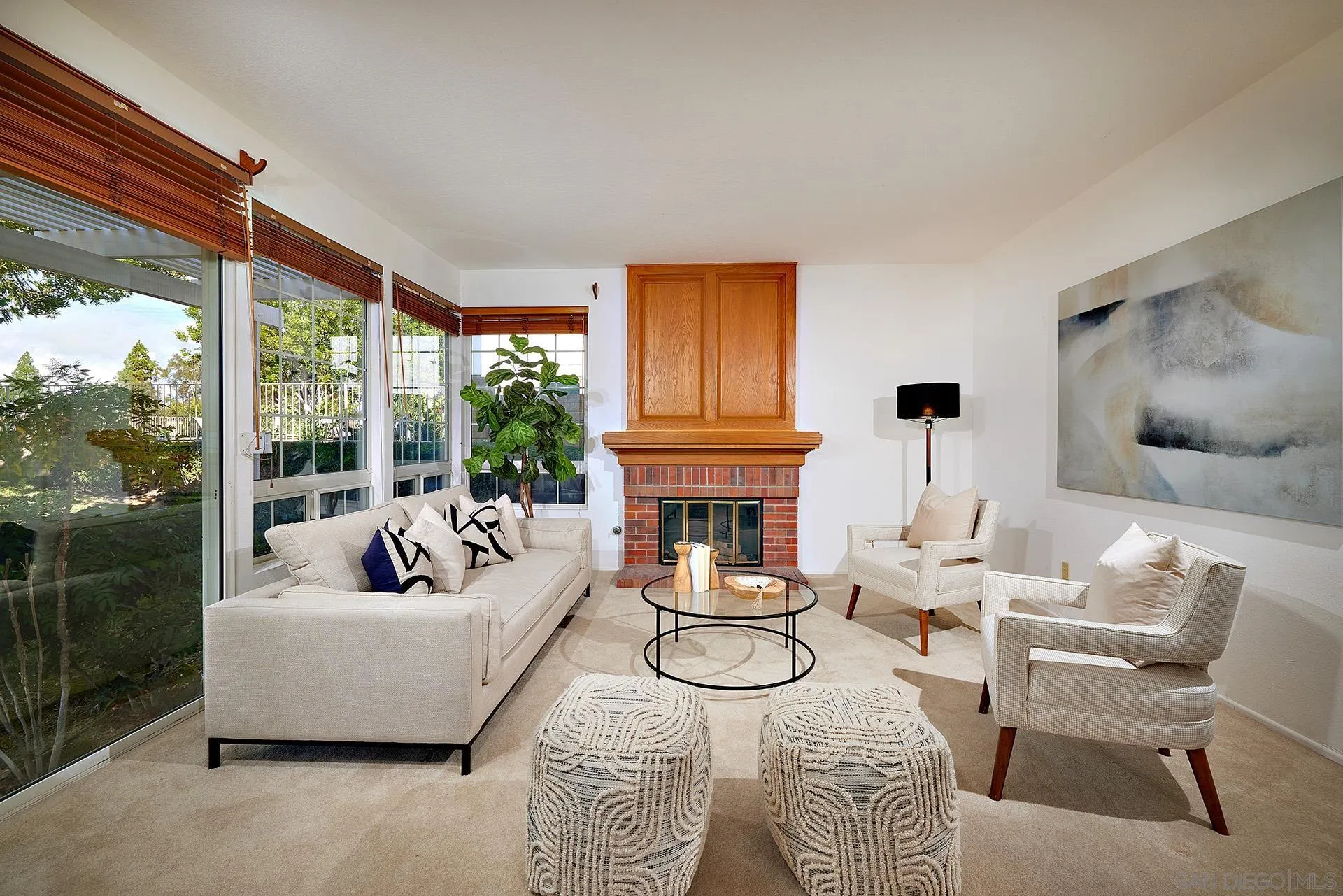 12490 Rue Cheaumont San Diego, CA 92131 - Photo 25 of 58 a living room with furniture a fireplace and a large window