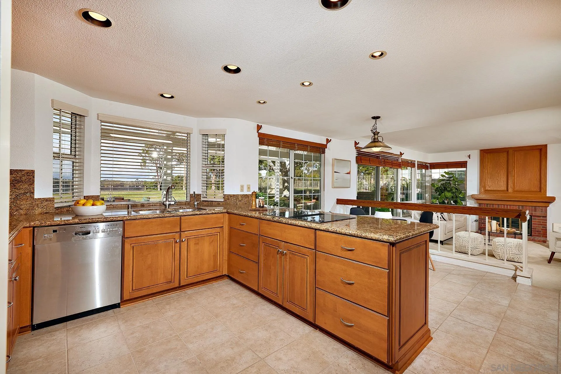 12490 Rue Cheaumont San Diego, CA 92131 - Photo 26 of 58 a kitchen with stainless steel appliances granite countertop a stove and more cabinets