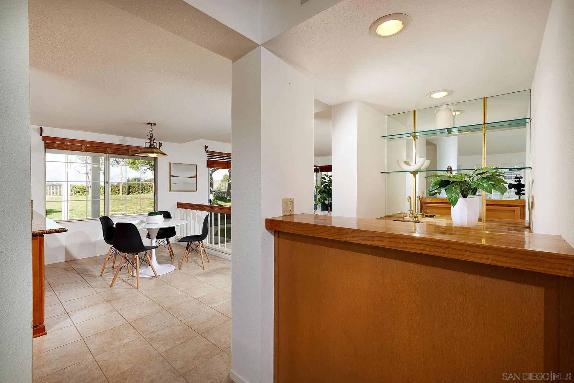 12490 Rue Cheaumont San Diego, CA 92131 - Photo 27 of 58 a dining hall with stainless steel appliances granite countertop a sink and a dining table view