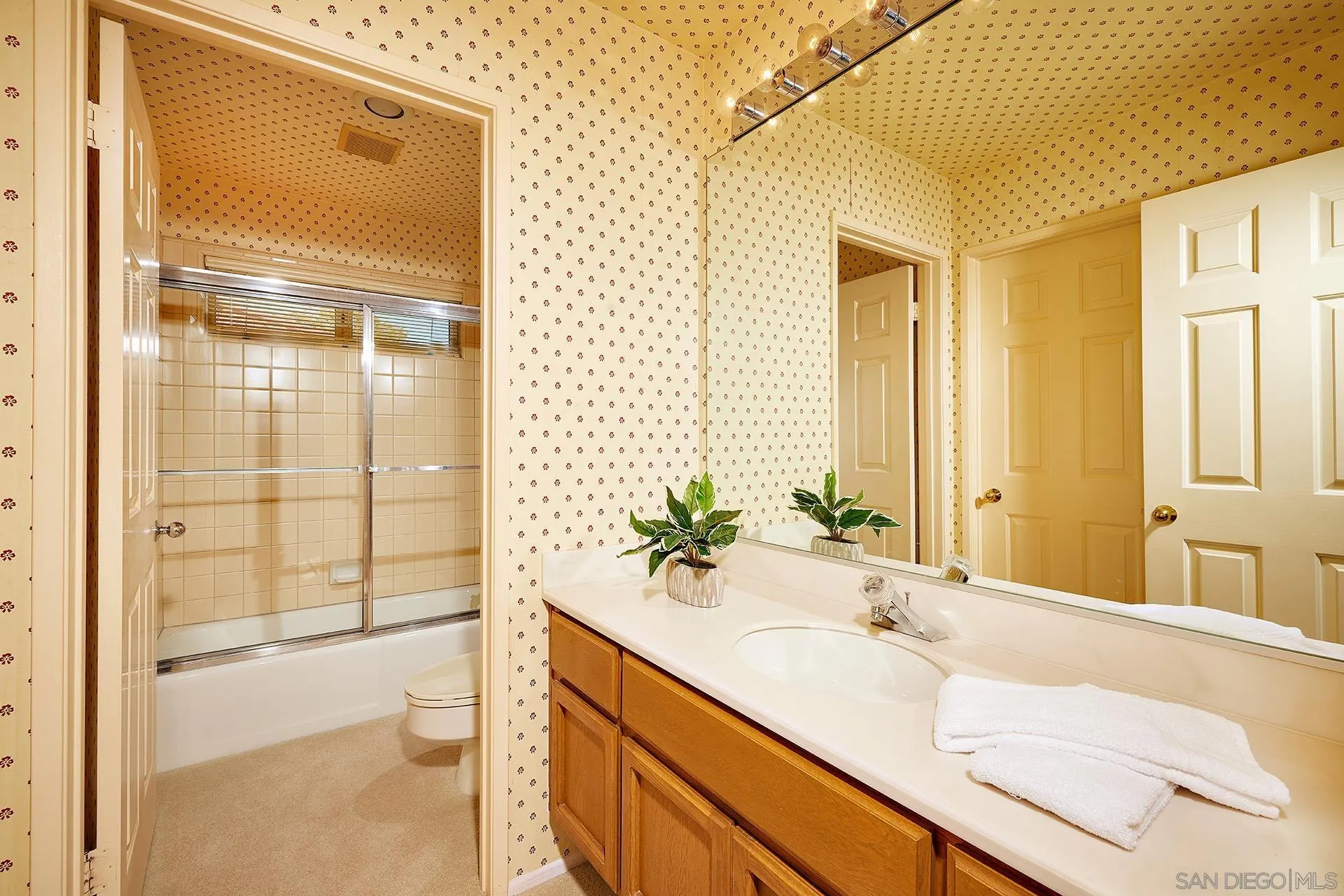 12490 Rue Cheaumont San Diego, CA 92131 - Photo 37 of 58 a bathroom with a granite countertop sink and a mirror
