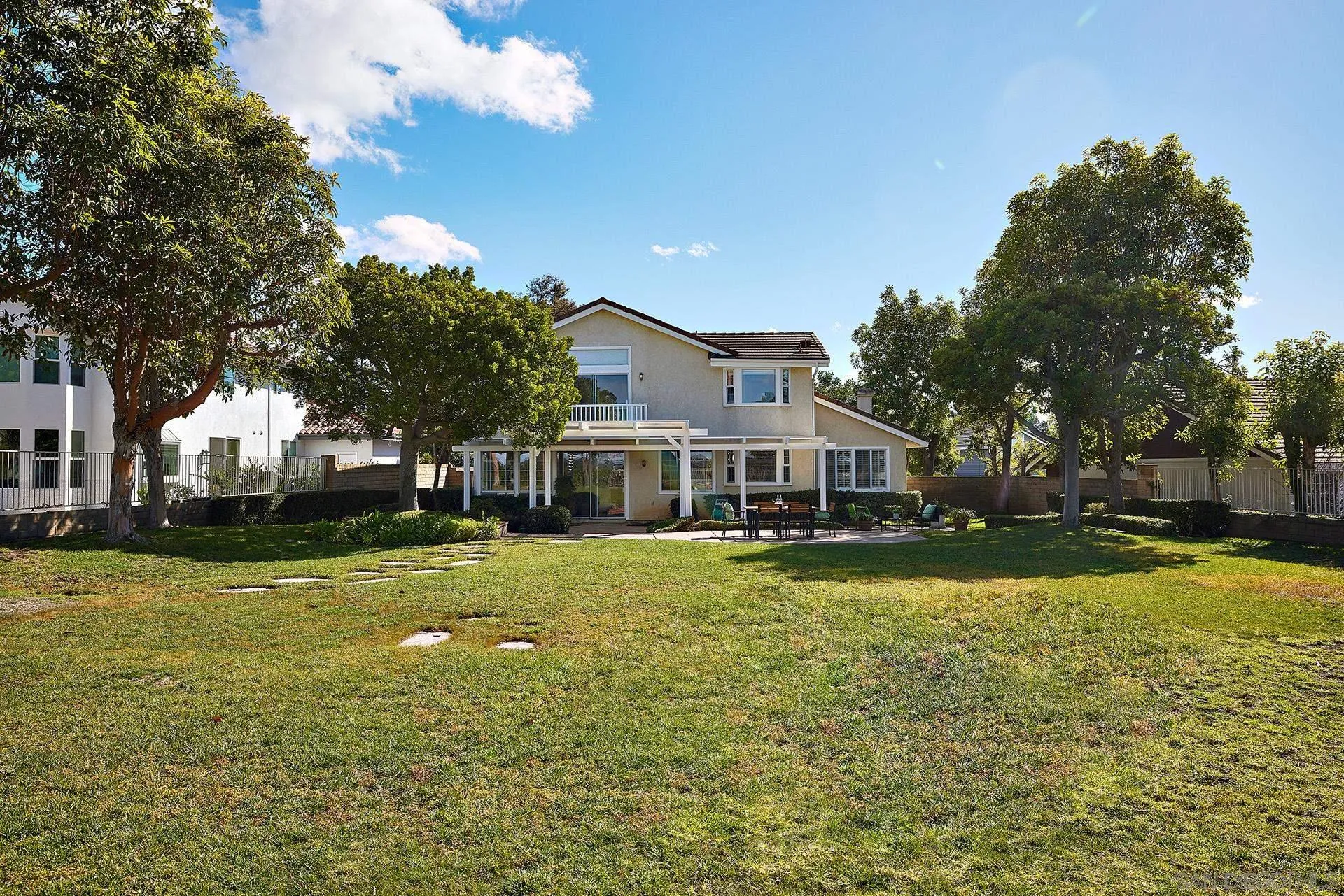 12490 Rue Cheaumont San Diego, CA 92131 - Photo 50 of 58 a front view of a house with a big yard