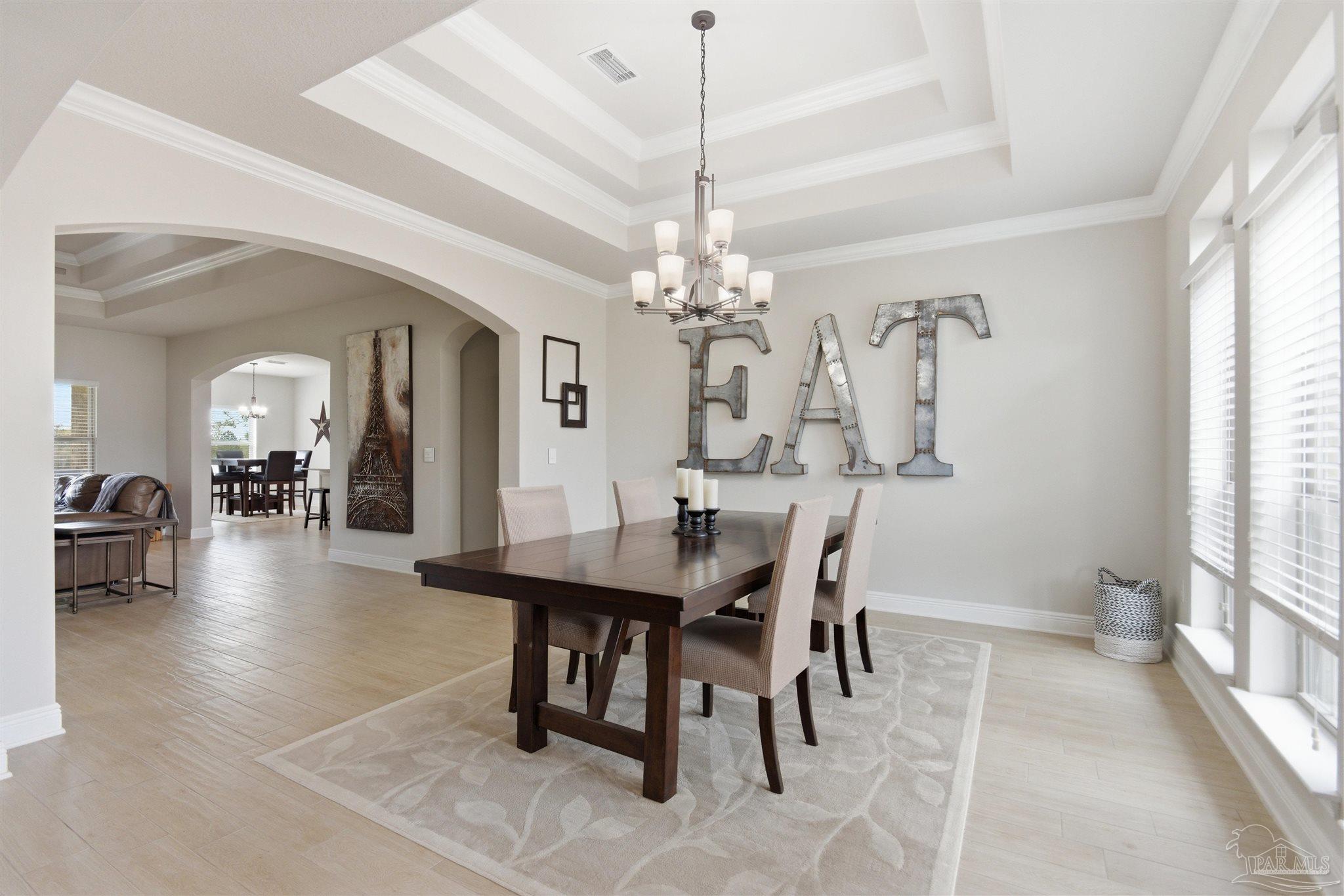 2677 Tulip Hill Road Pace, FL 32571 - Photo 6 of 35 a view of a dining room with furniture and chandelier