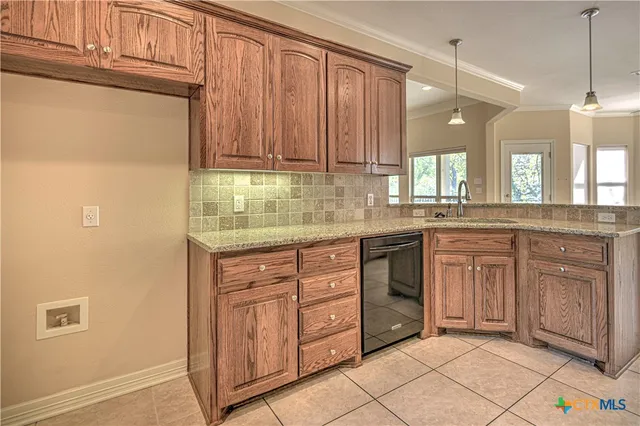 a kitchen with granite countertop a stove top oven microwave and cabinets