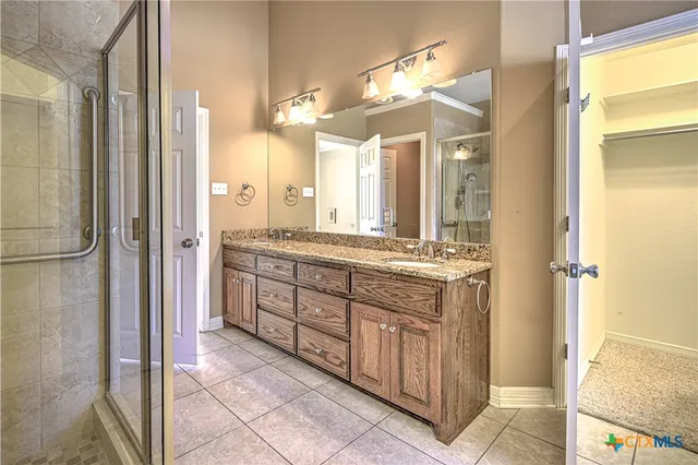 a bathroom with a shower and a glass door