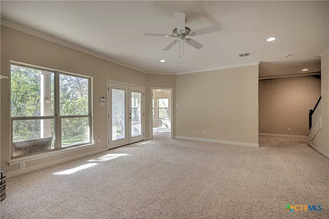 a view of an empty room with a fireplace and a window