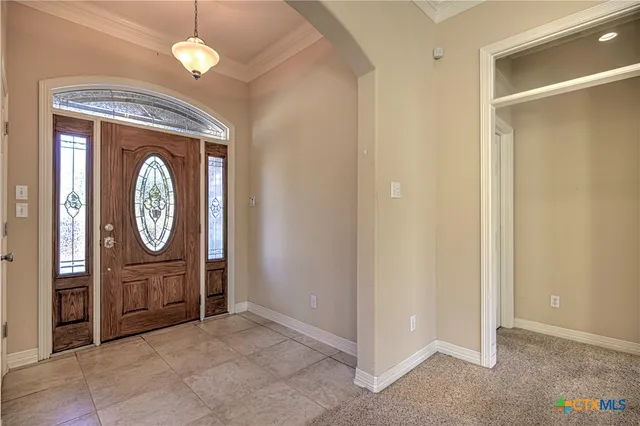 a view of a livingroom with furniture and bathroom with a mirror