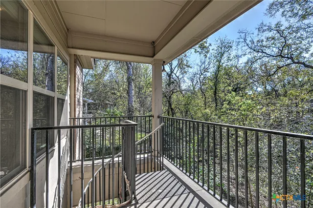 a view of a balcony with wooden floor