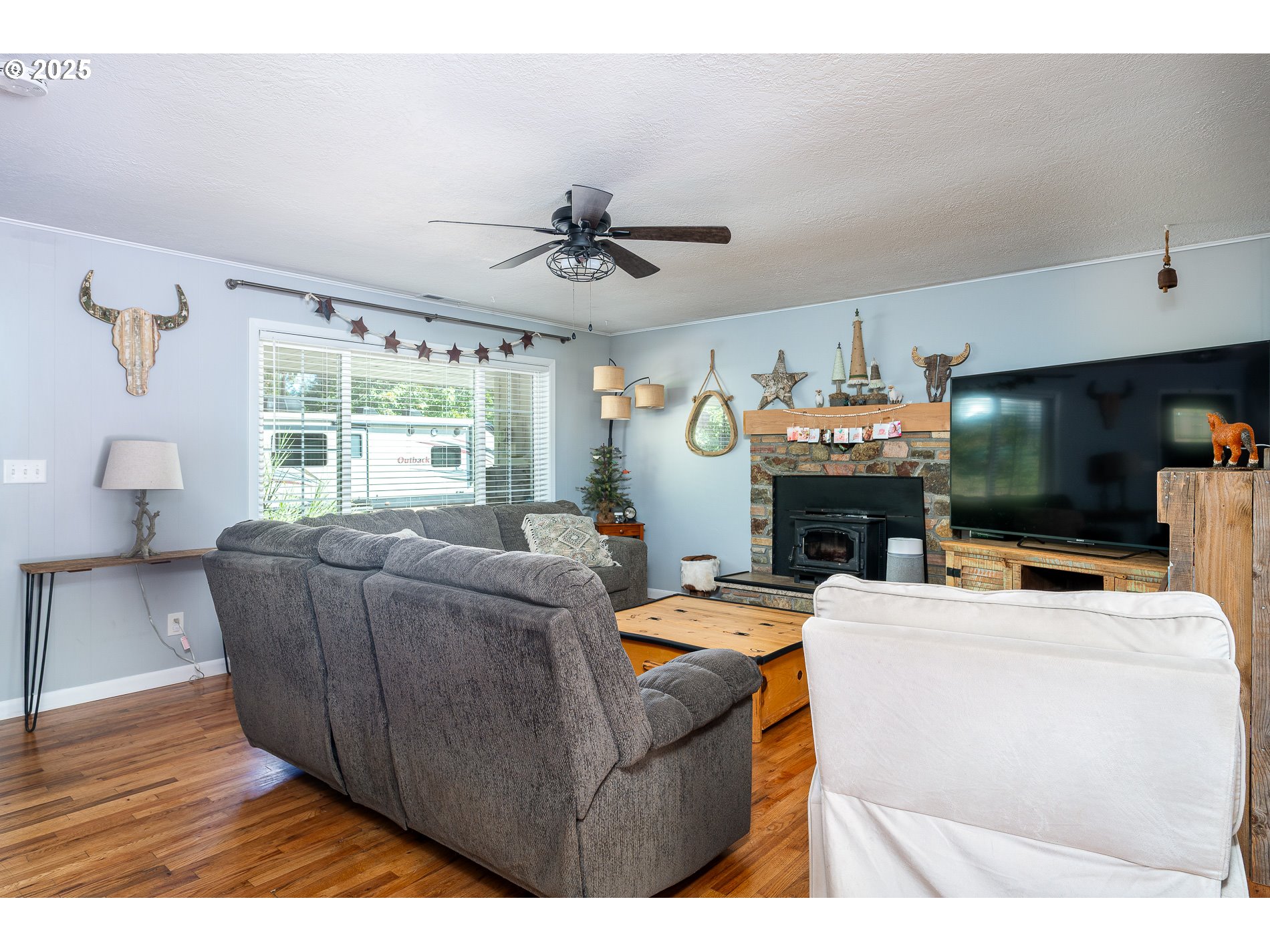 23636 Highway 224 Boring, OR 97009 - Photo 12 of 48 a living room with furniture a fireplace and a flat screen tv
