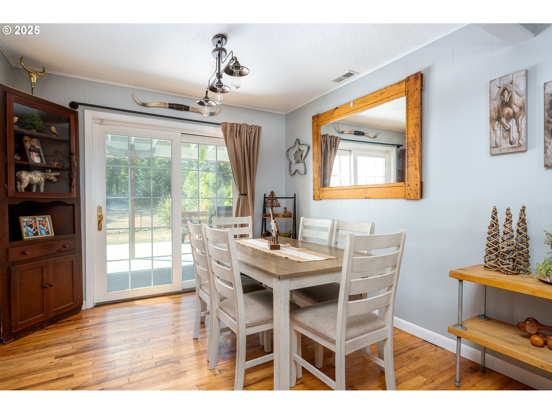 23636 Highway 224 Boring, OR 97009 - Photo 13 of 48 a dining room with furniture a chandelier and wooden floor