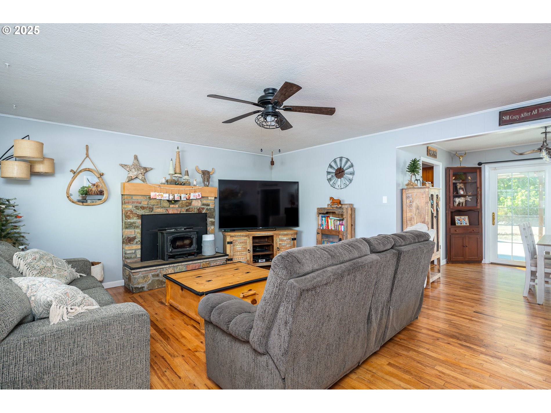 23636 Highway 224 Boring, OR 97009 - Photo 9 of 48 a living room with furniture a flat screen tv and a fireplace
