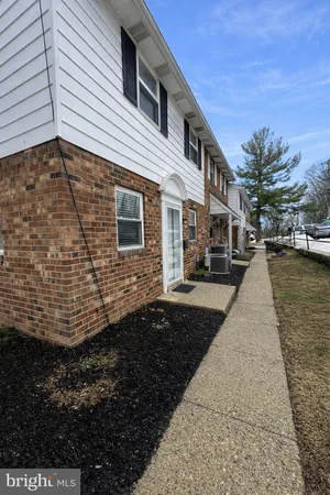 a pathway of a house with a yard