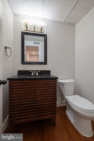 a bathroom with a toilet a sink and mirror