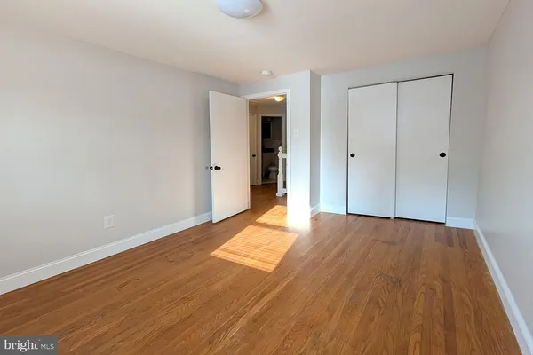 a view of an empty room and wooden floor