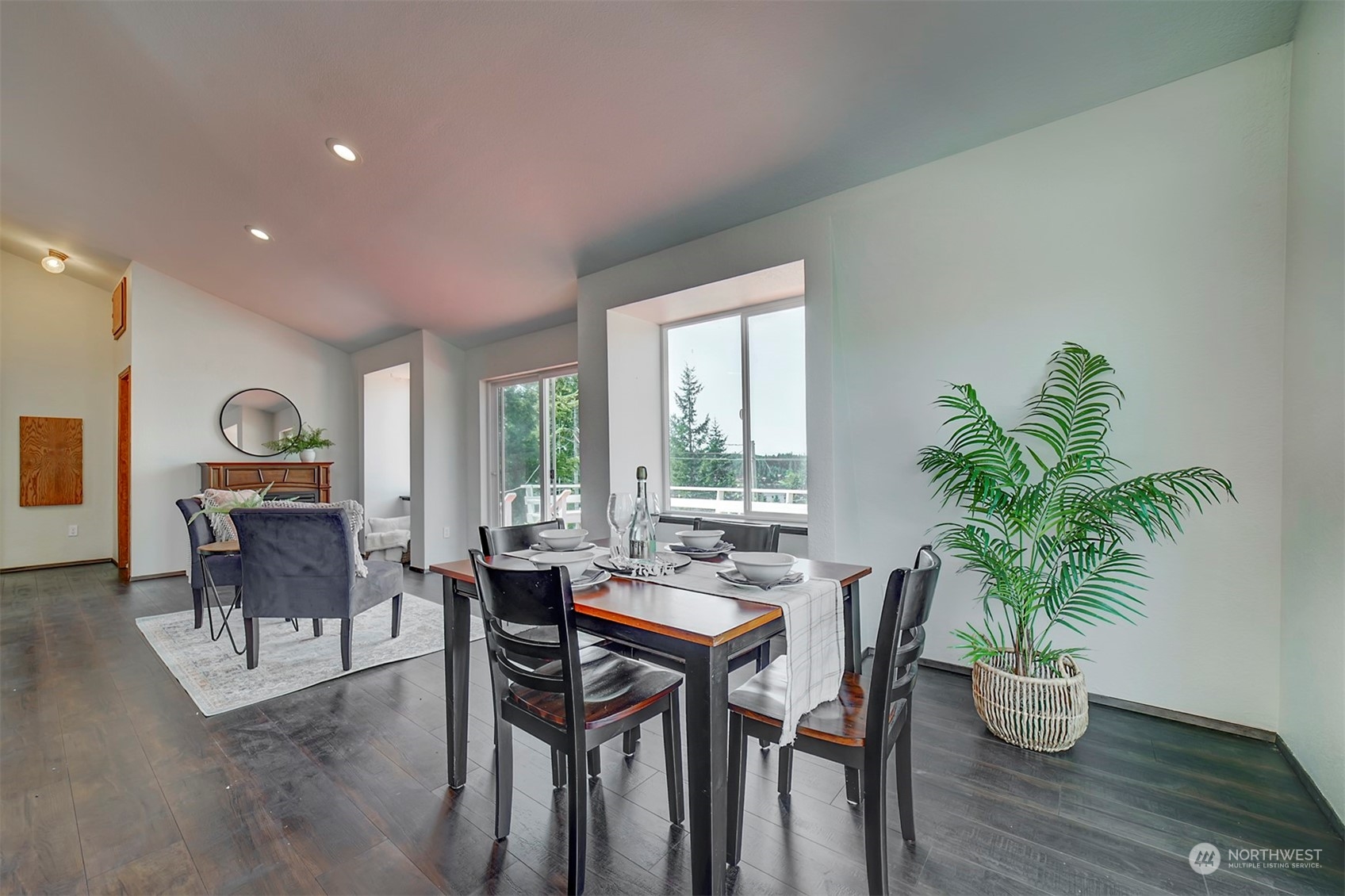220 East Olympic Drive Grapeview, WA 98546 - Photo 11 of 40 a dining room with furniture potted plants and wooden floor