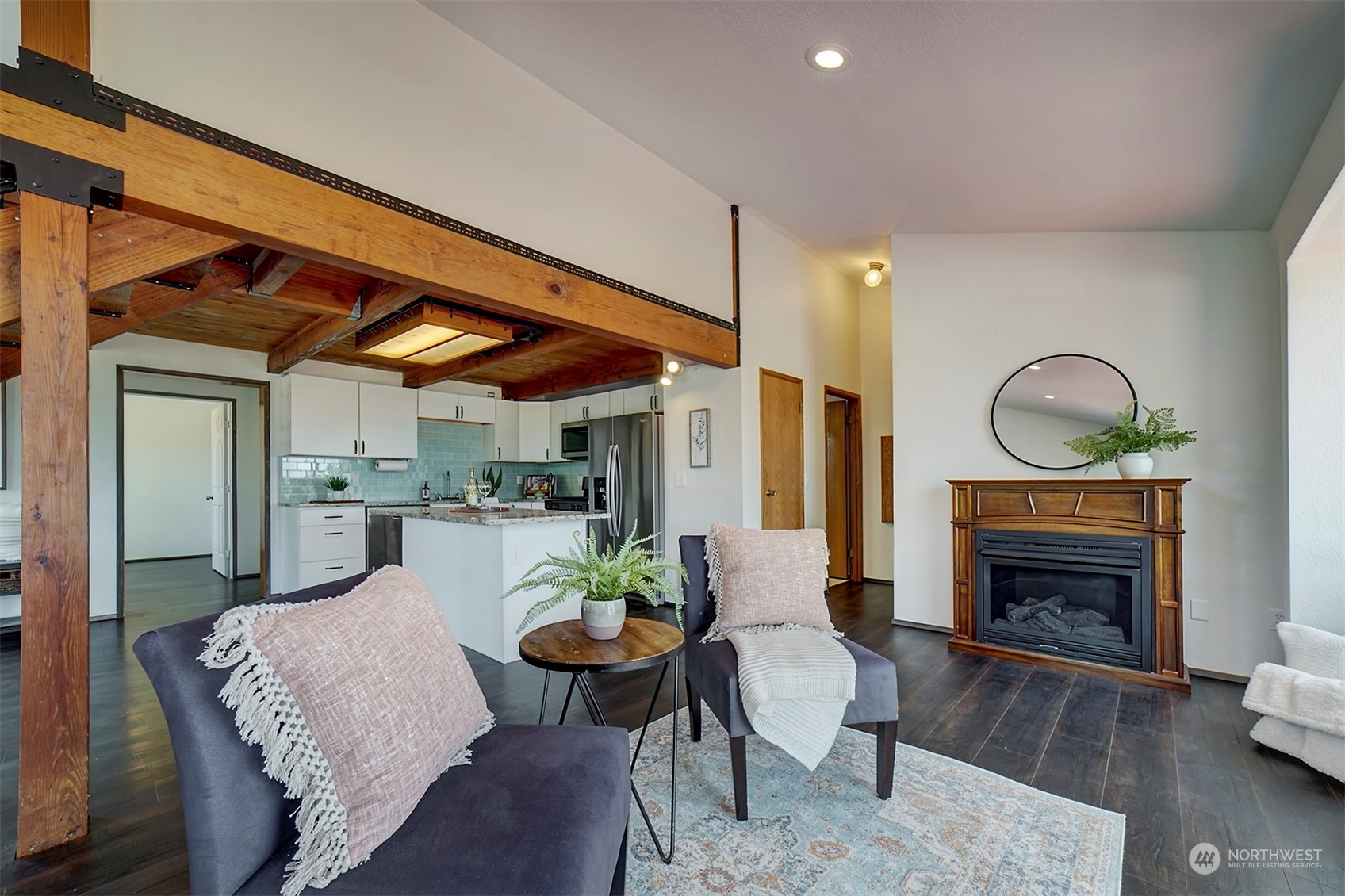 220 East Olympic Drive Grapeview, WA 98546 - Photo 13 of 40 a living room with furniture a fireplace a rug and a window