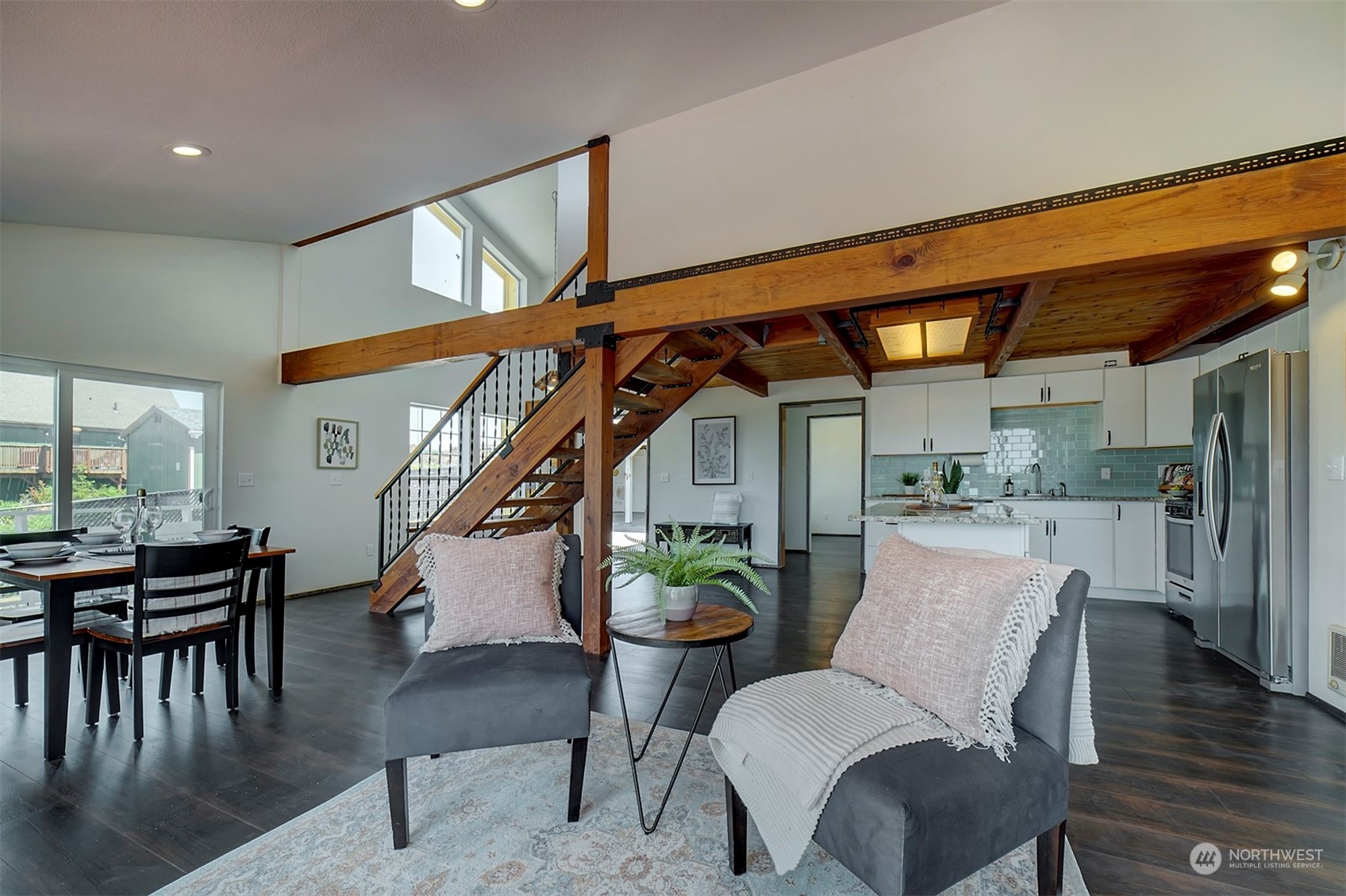 220 East Olympic Drive Grapeview, WA 98546 - Photo 14 of 40 a dining room with furniture a rug and wooden floor