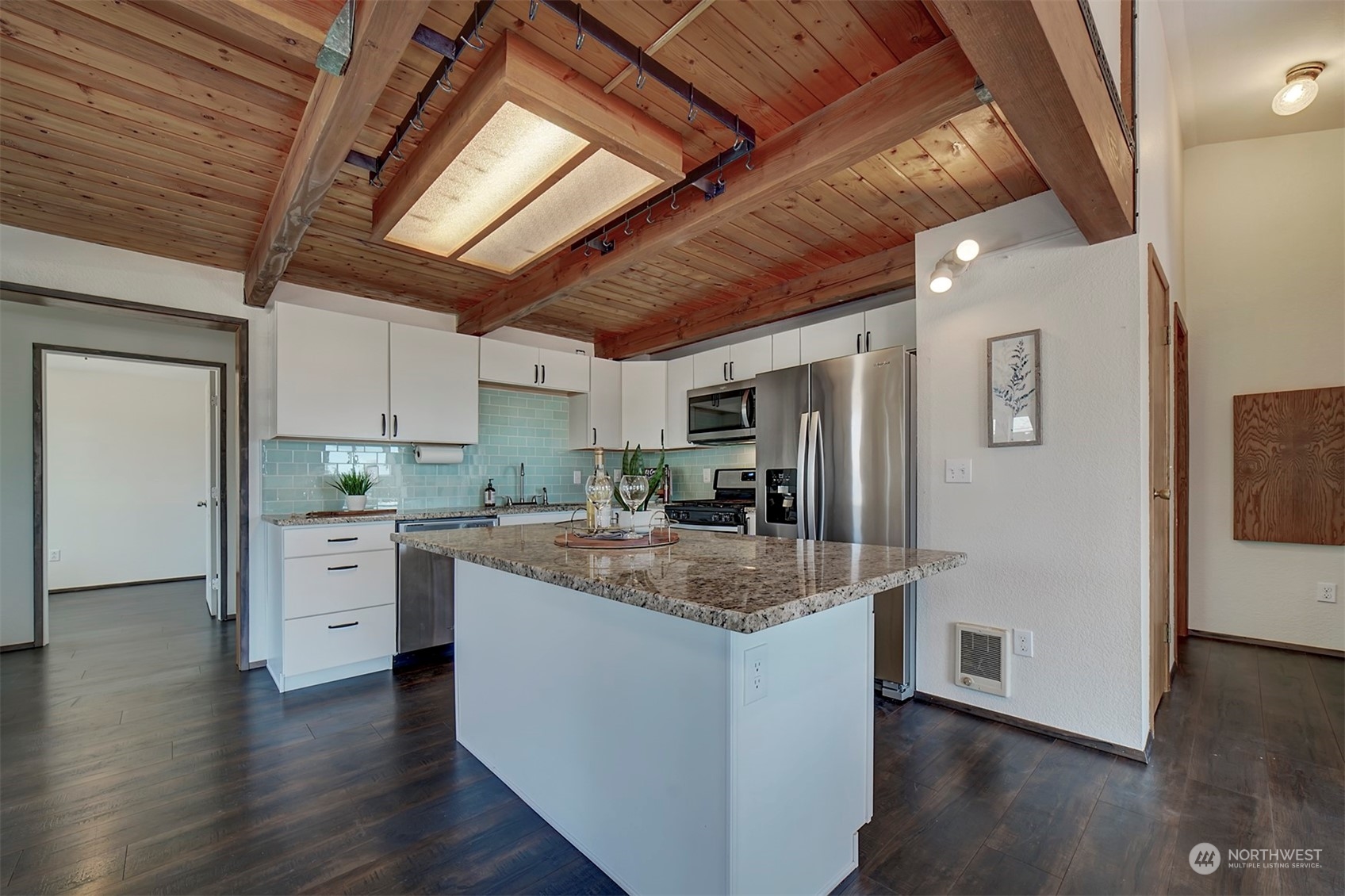 220 East Olympic Drive Grapeview, WA 98546 - Photo 15 of 40 a kitchen with stove cabinets and wooden floor