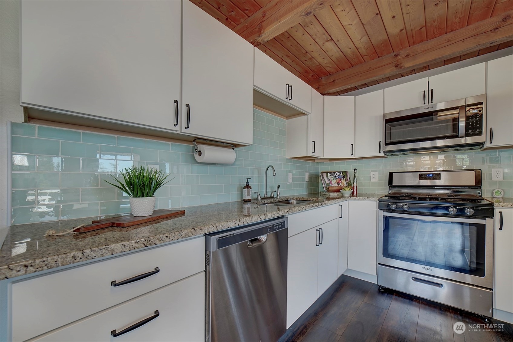 220 East Olympic Drive Grapeview, WA 98546 - Photo 17 of 40 a kitchen with stainless steel appliances granite countertop a stove a sink and a microwave