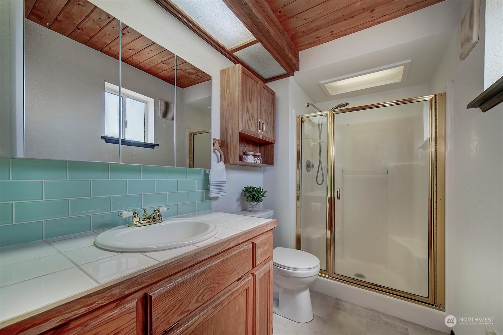 220 East Olympic Drive Grapeview, WA 98546 - Photo 21 of 40 a bathroom with a granite countertop sink toilet and shower