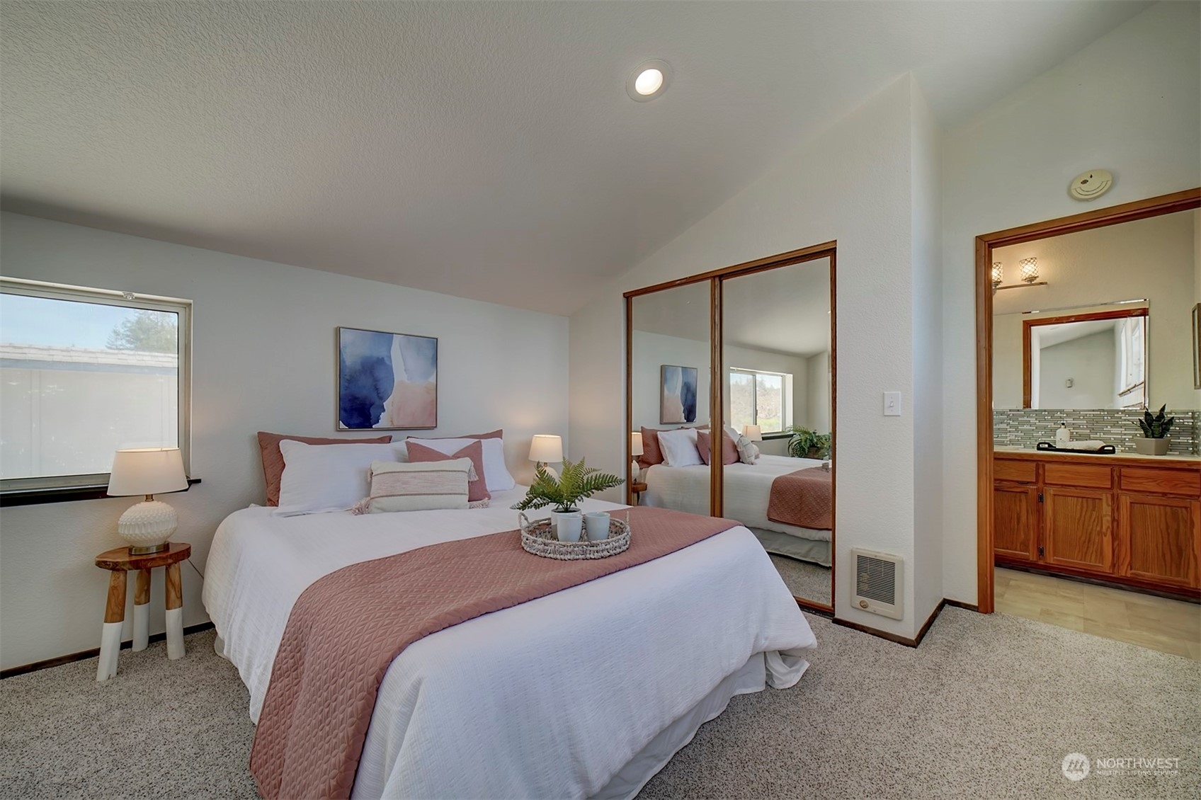 220 East Olympic Drive Grapeview, WA 98546 - Photo 29 of 40 a bedroom with a bed and a large mirror