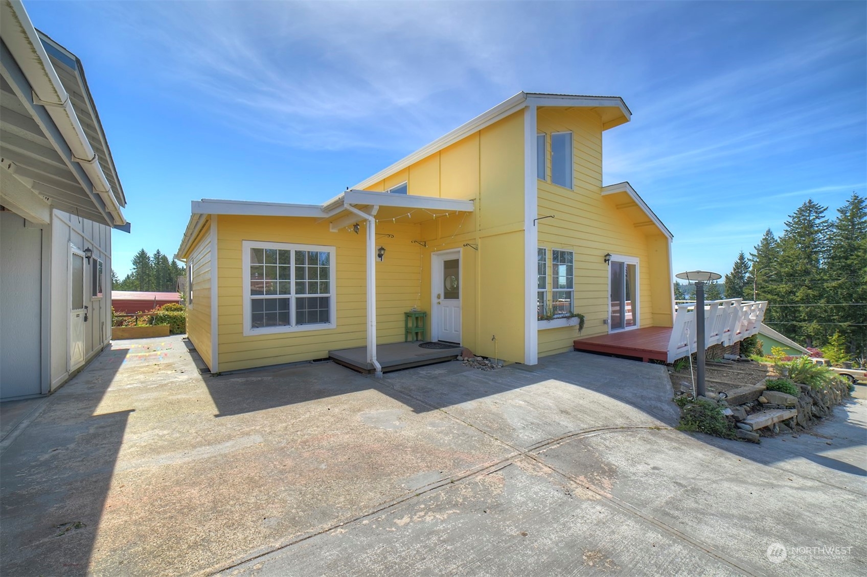 220 East Olympic Drive Grapeview, WA 98546 - Photo 3 of 40 a view of a house with backyard and porch