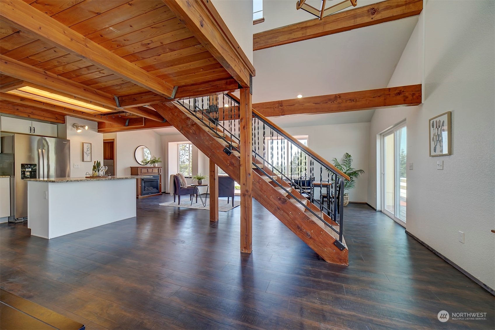 220 East Olympic Drive Grapeview, WA 98546 - Photo 7 of 40 a view of staircase with lots of frames on wall and windows